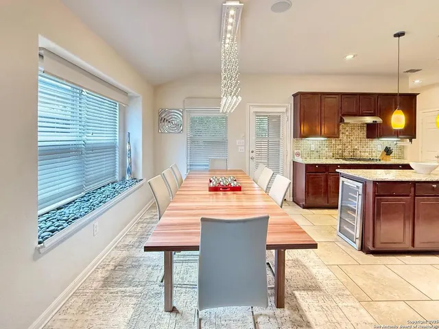 a dining hall with granite countertop a sink and a table