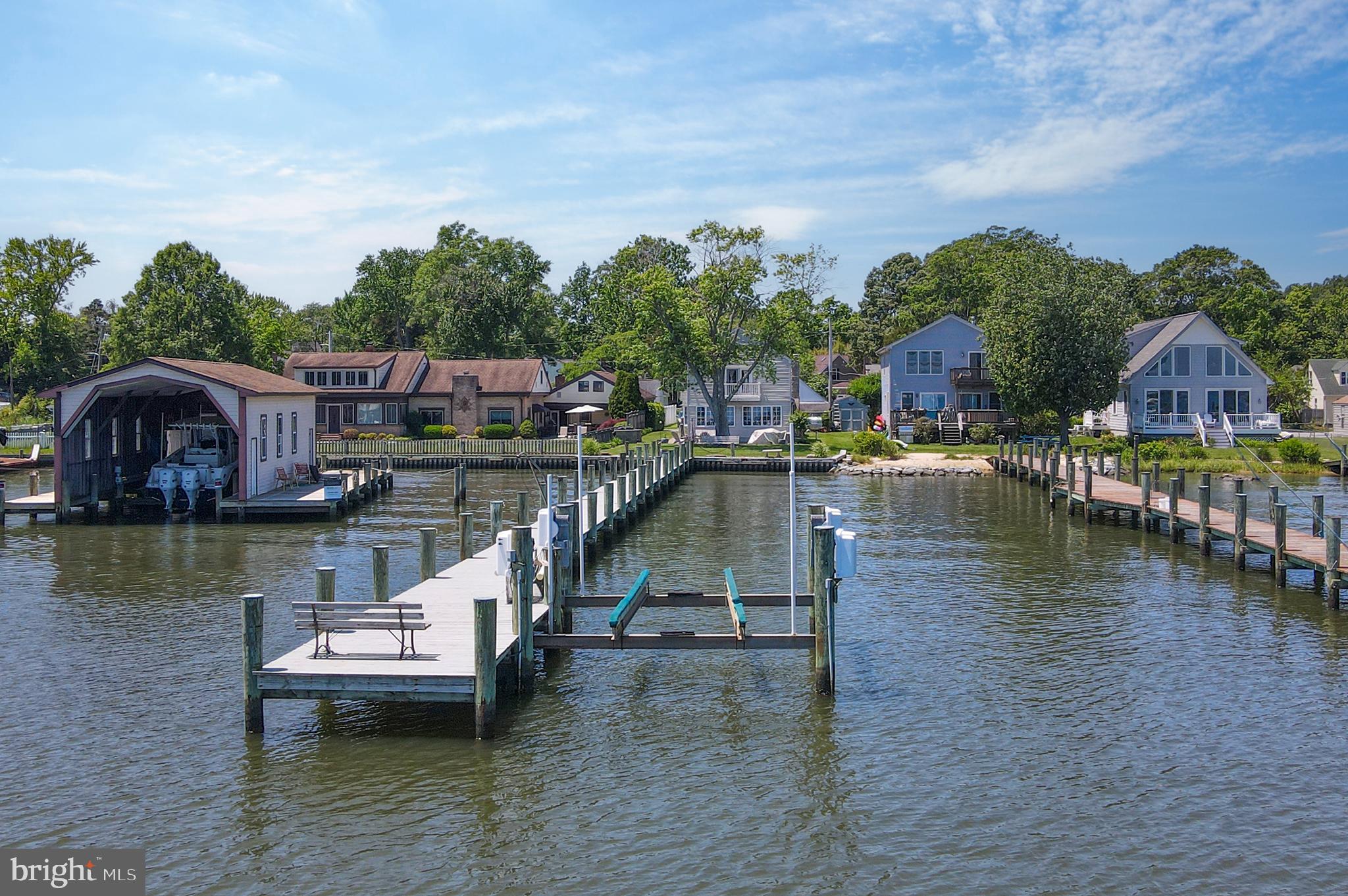 a view of house with yard and lake view