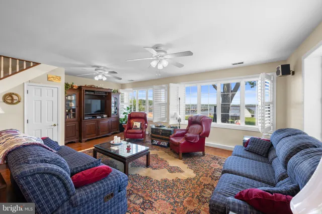 a living room with furniture ceiling fan and a rug