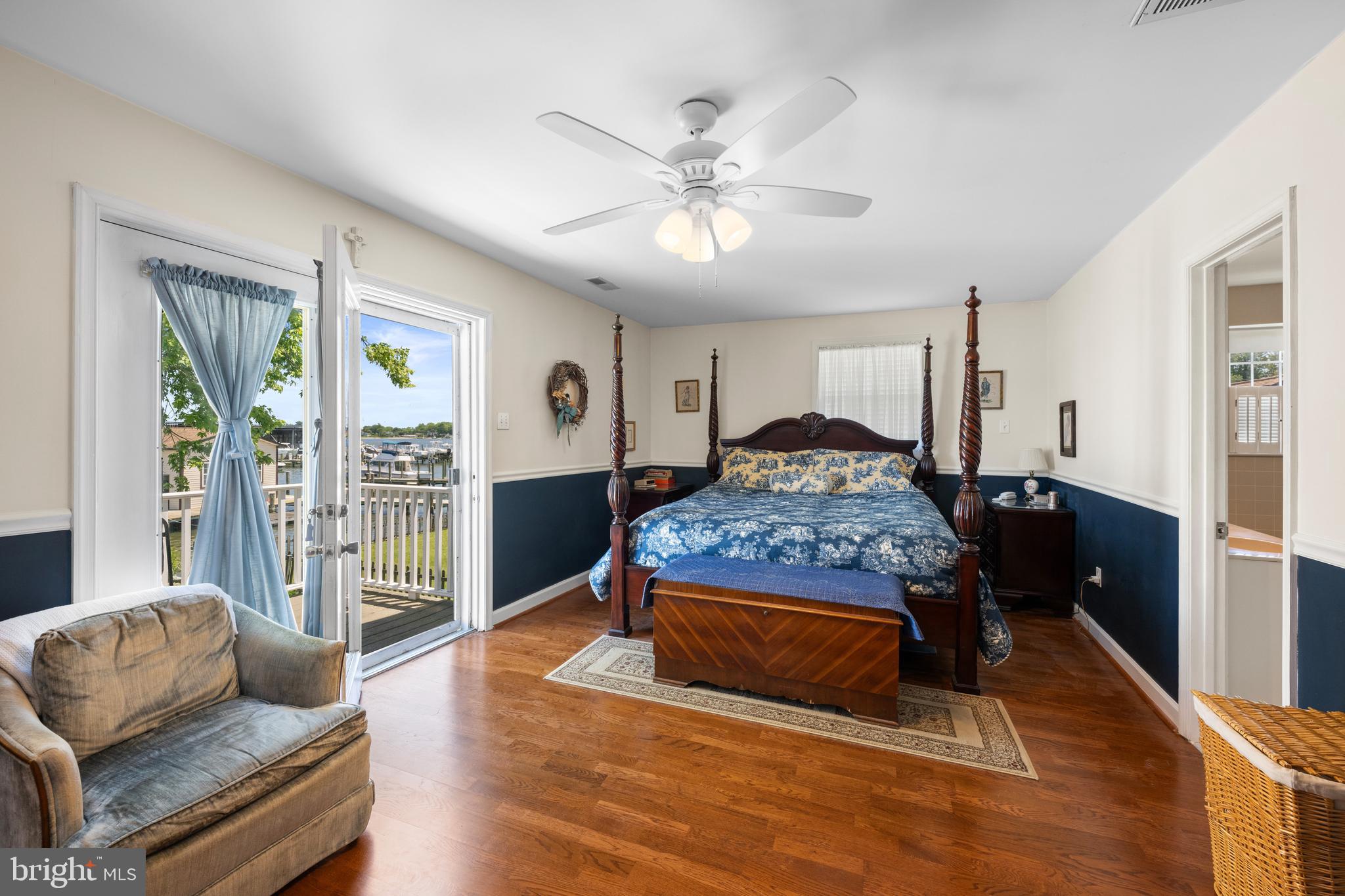 3685 1st Avenue Edgewater, MD 21037 - Photo 21 of 41 a bedroom with a large bed a couch and a chandelier
