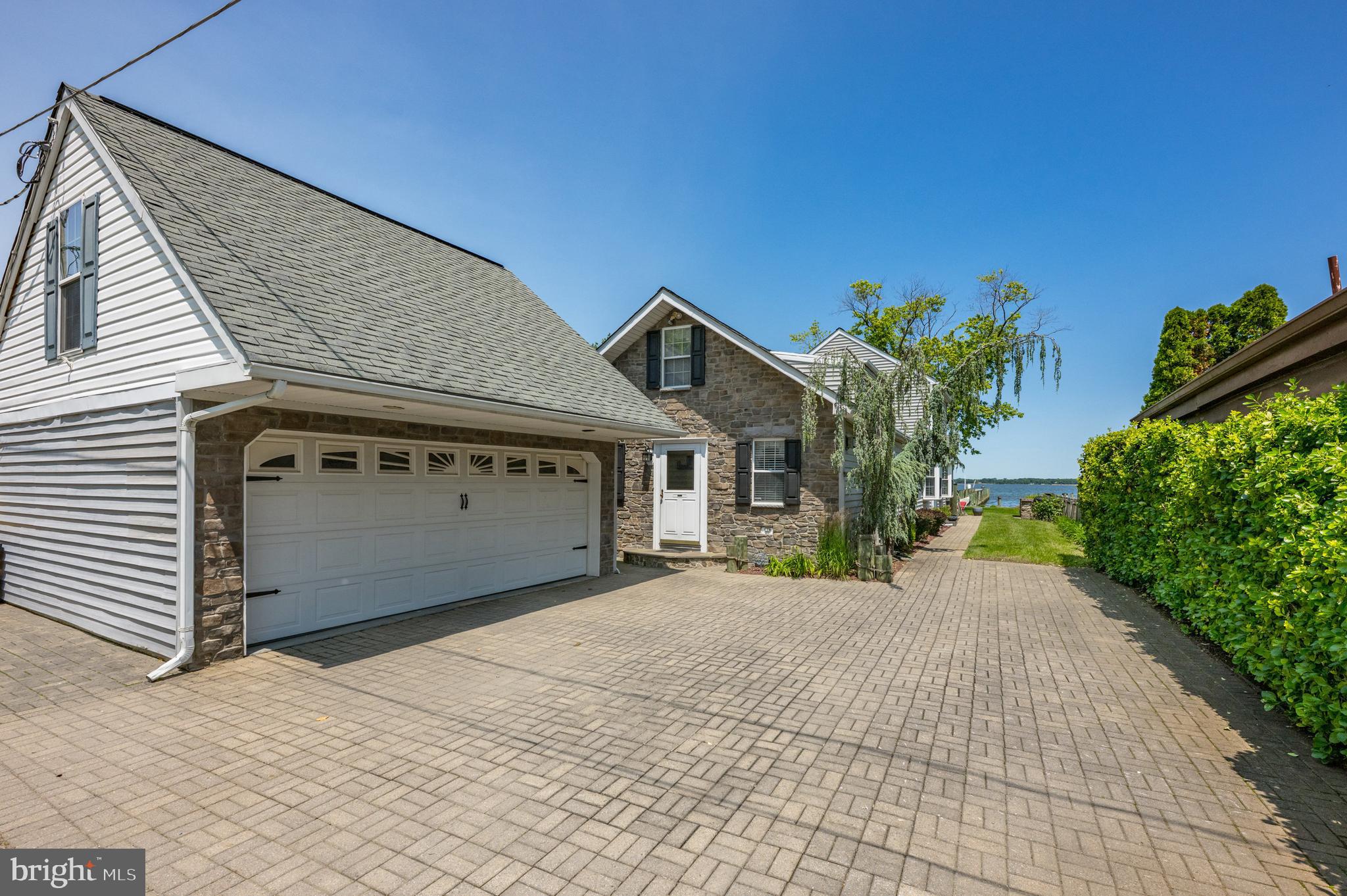 3685 1st Avenue Edgewater, MD 21037 - Photo 4 of 41 a front view of a house with a yard and garage