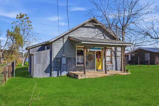 a view of a backyard with sitting area