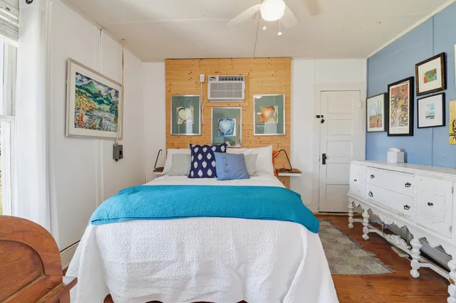 a dining room with wooden floor a table and chairs