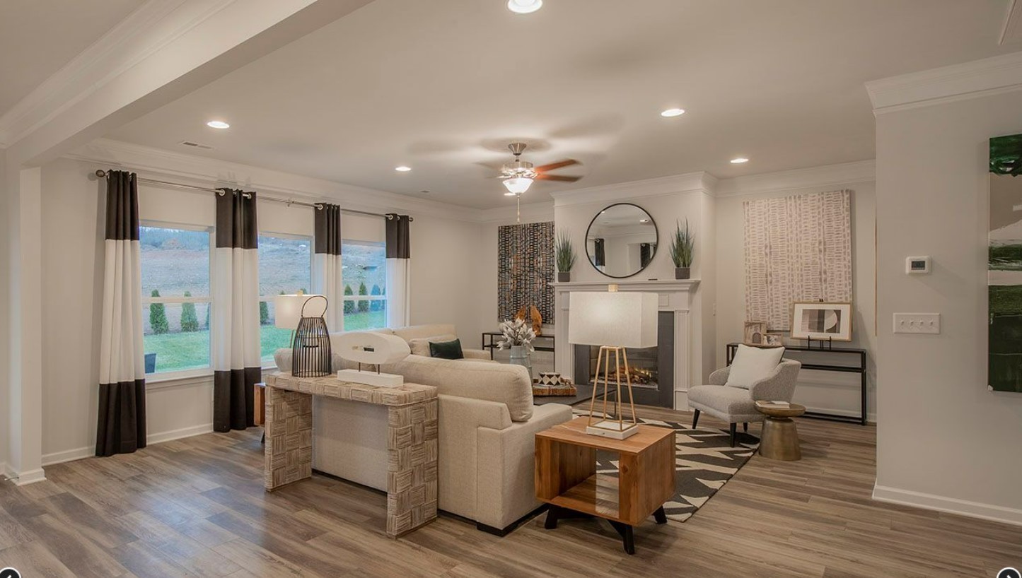 3633 Capstone Court Murfreesboro, TN 37128 - Photo 4 of 14 a living room with furniture a wooden floor and a chandelier