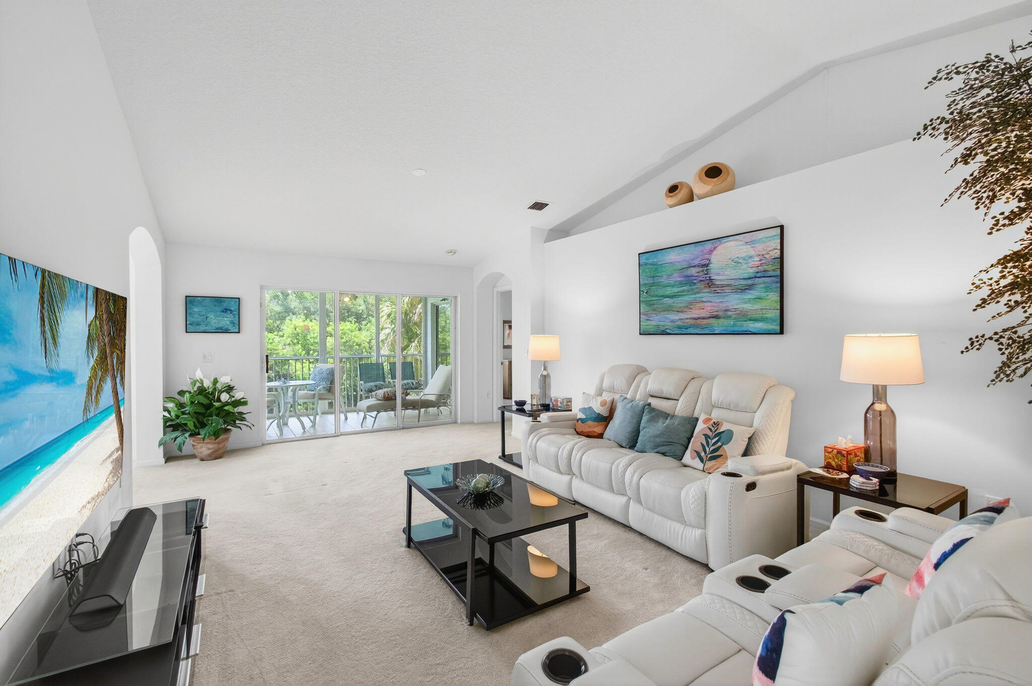 7676 Springwater Place, Unit 201 Boynton Beach, FL 33437 - Photo 11 of 36 a living room with furniture and a flat screen tv