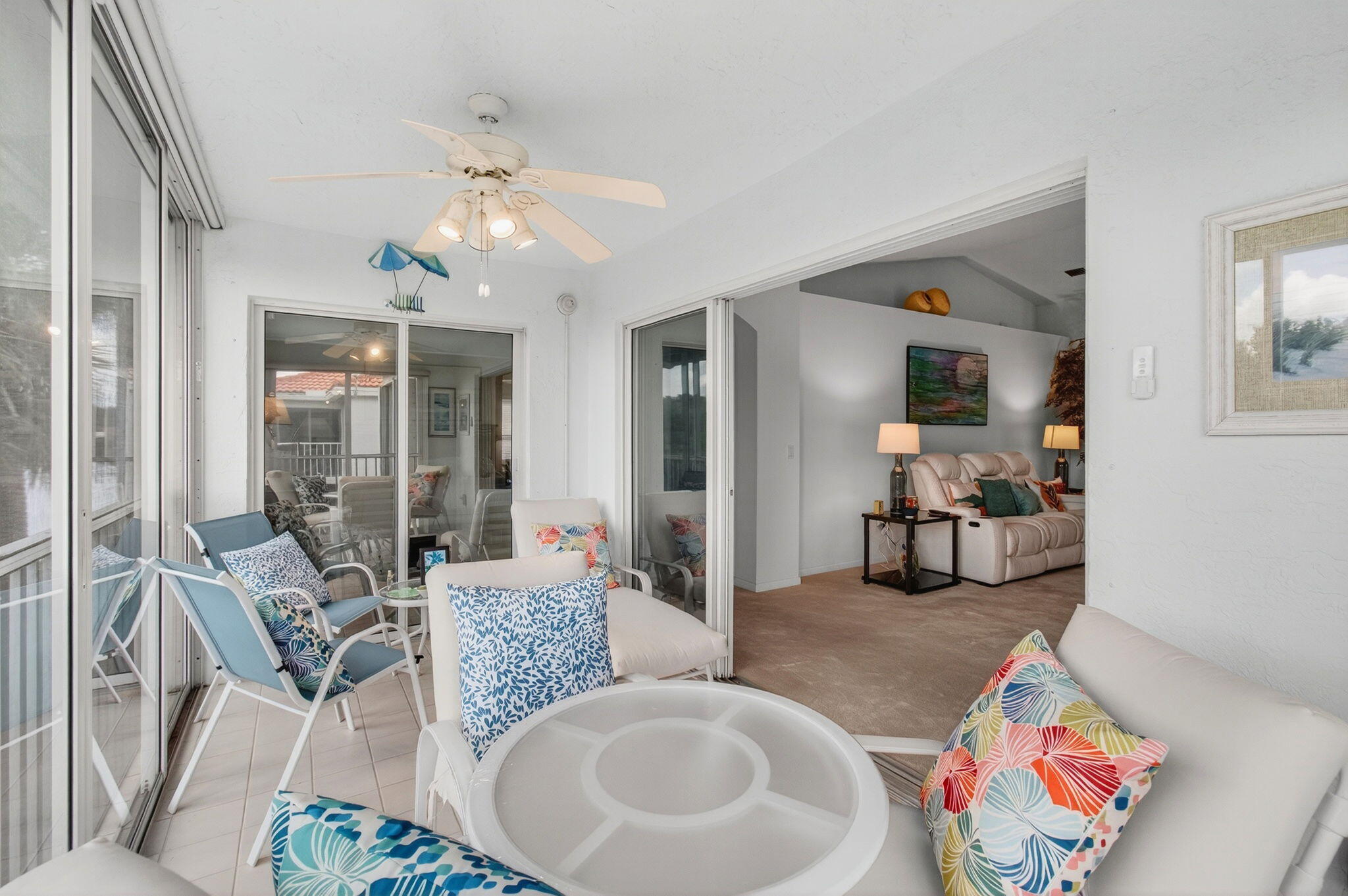 7676 Springwater Place, Unit 201 Boynton Beach, FL 33437 - Photo 16 of 36 a living room with furniture and a chandelier