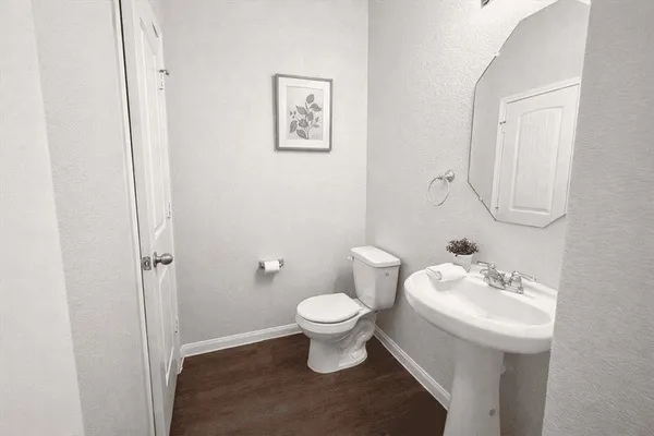 a bathroom with a toilet sink and a mirror