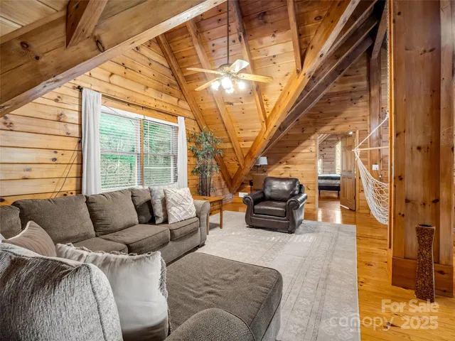 a bedroom with furniture and large windows