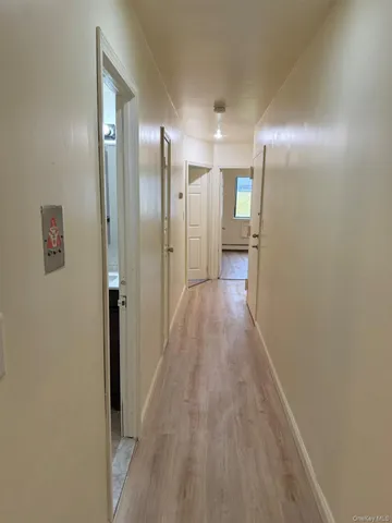 a view of a hallway with wooden floor