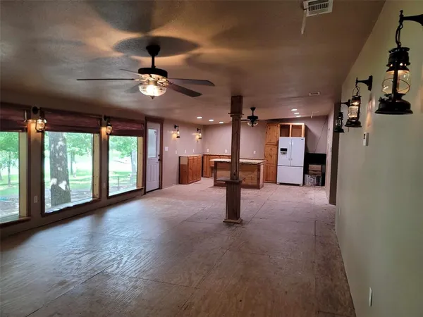 a view of a livingroom with a ceiling fan and window