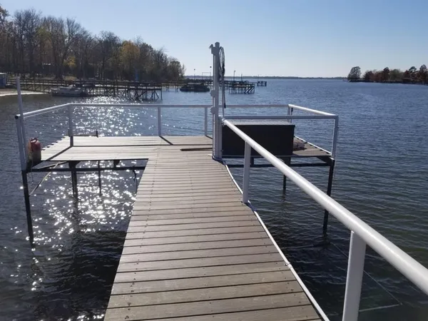 a view of a wooden deck with a yard