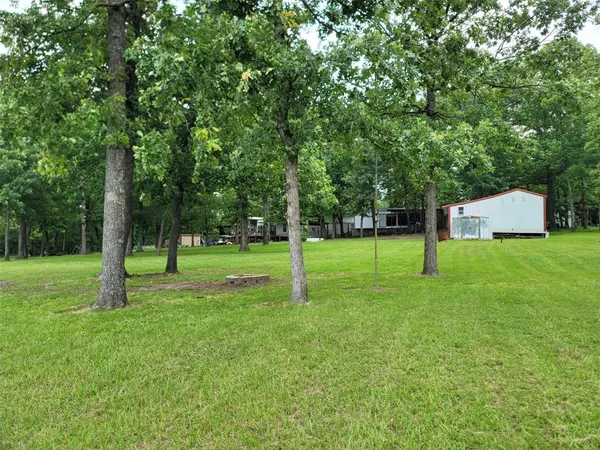 a front view of a house with a garden and trees