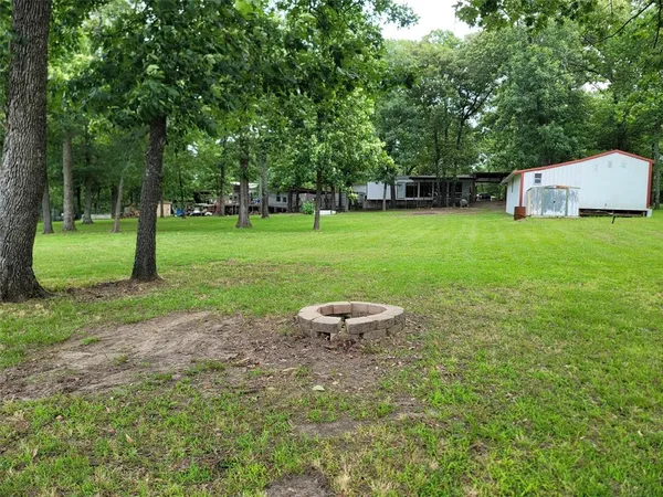 a view of a room with wooden floor and windows