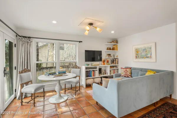 a living room with furniture and a flat screen tv