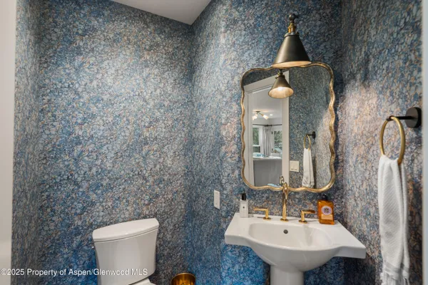 a bathroom with a toilet sink and mirror