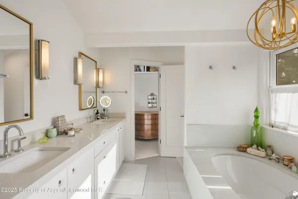 a spacious bathroom with a granite countertop tub sink and mirror