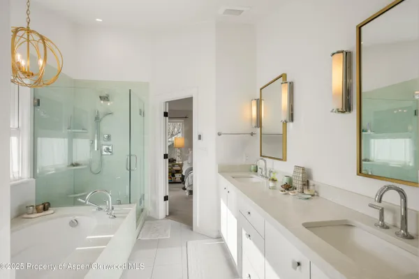 a bathroom with a tub sink and mirror