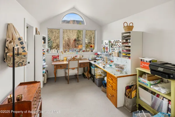 a view of a room with workspace and a window