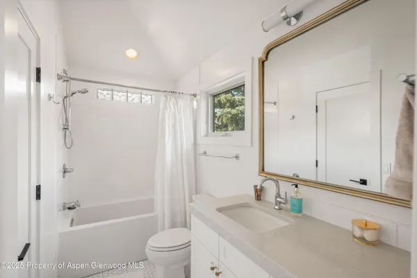 a living room with furniture a lamp and a large window