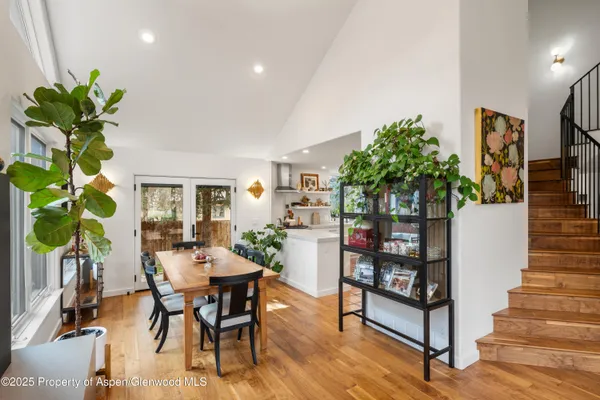 a view of a dining room with furniture and a potted plant