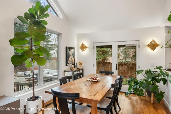 a view of a dining room with furniture window and wooden floor