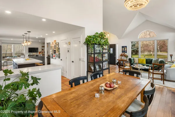 a view of a dining room with furniture and a floor to ceiling window