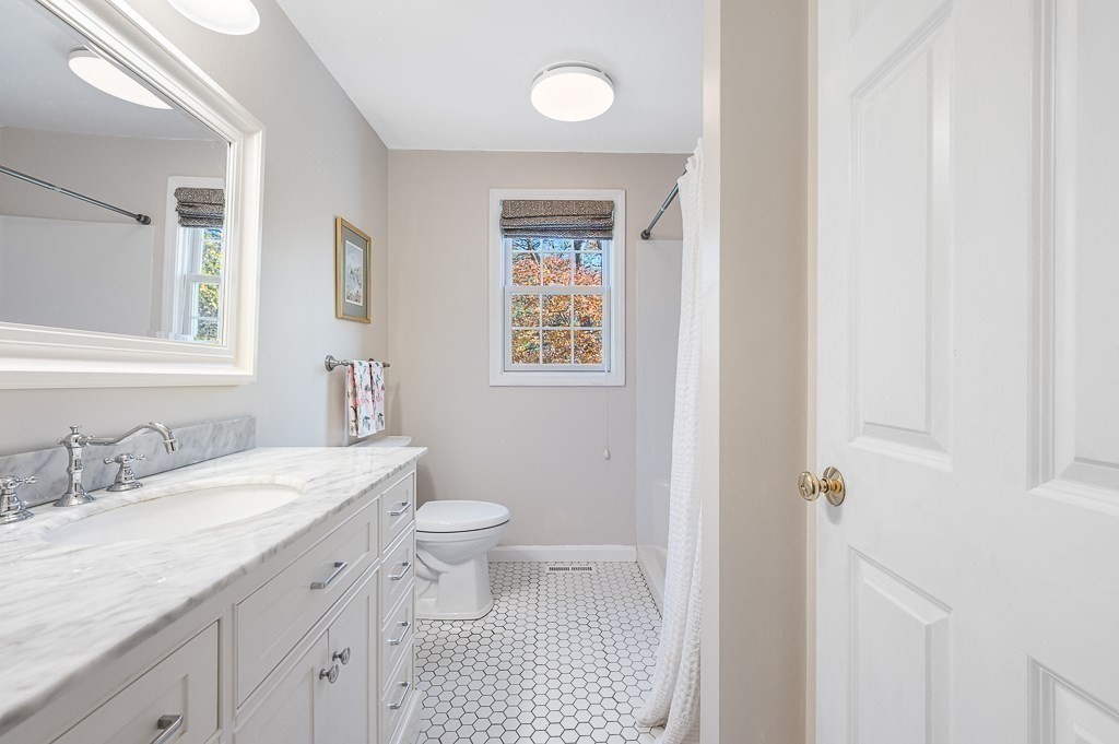 115 Ariel Circle, Unit 115 Sutton, MA 01590 - Photo 16 of 39 a bathroom with a granite countertop sink toilet and shower