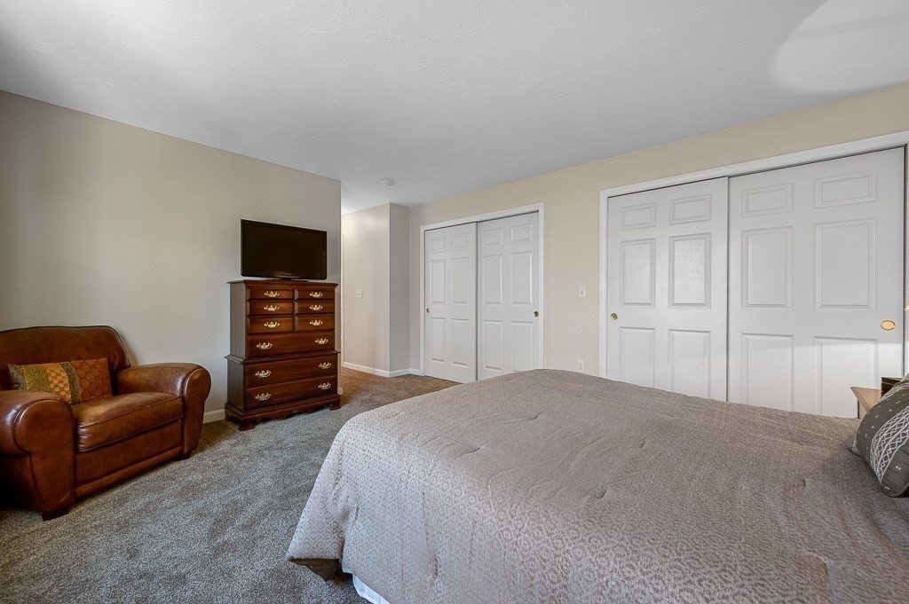 115 Ariel Circle, Unit 115 Sutton, MA 01590 - Photo 19 of 39 a bedroom with a bed and a couch