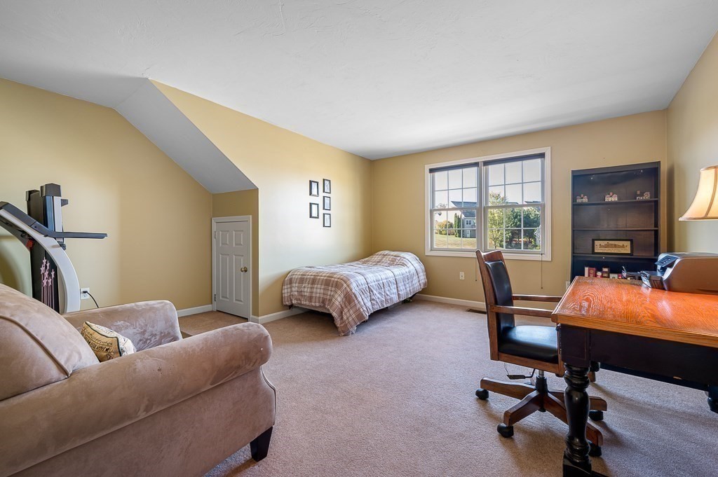 115 Ariel Circle, Unit 115 Sutton, MA 01590 - Photo 22 of 39 a bedroom with furniture and a window