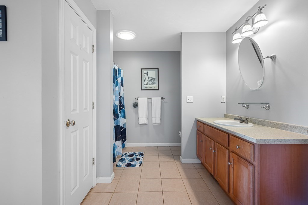 115 Ariel Circle, Unit 115 Sutton, MA 01590 - Photo 24 of 39 a bathroom with a double vanity sink mirror and shower