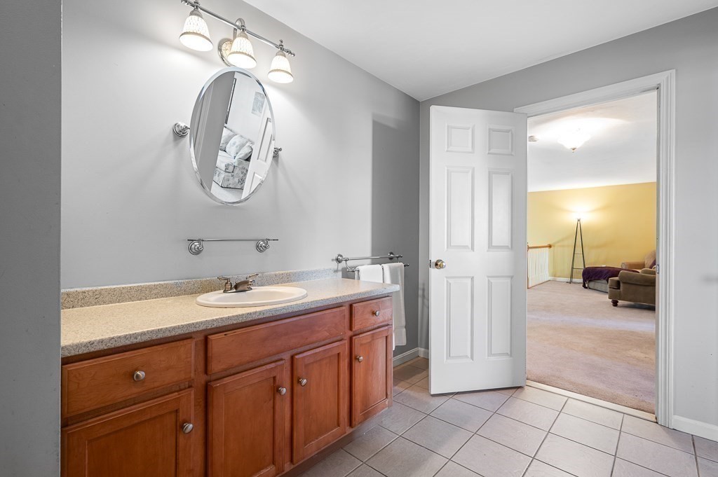 115 Ariel Circle, Unit 115 Sutton, MA 01590 - Photo 25 of 39 a spacious bathroom with a double vanity sink and a mirror
