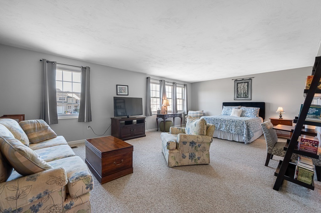 115 Ariel Circle, Unit 115 Sutton, MA 01590 - Photo 26 of 39 a bedroom with furniture and a couch
