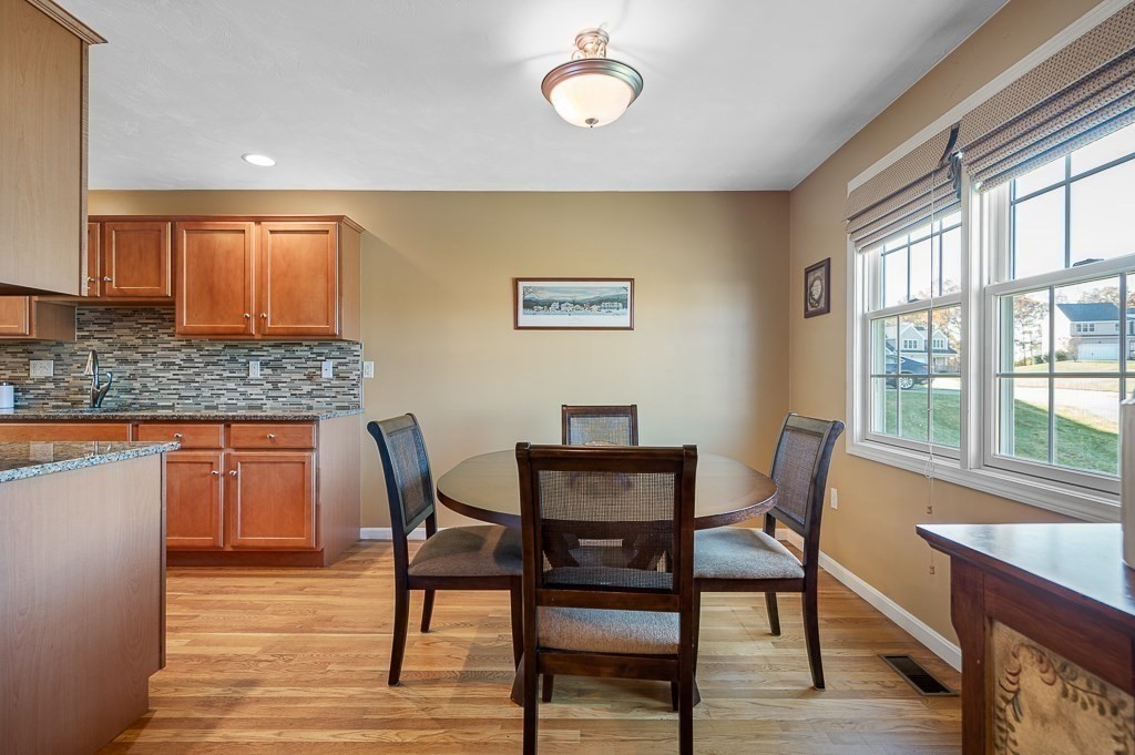 115 Ariel Circle, Unit 115 Sutton, MA 01590 - Photo 6 of 39 a view of a dining room with furniture and wooden floor