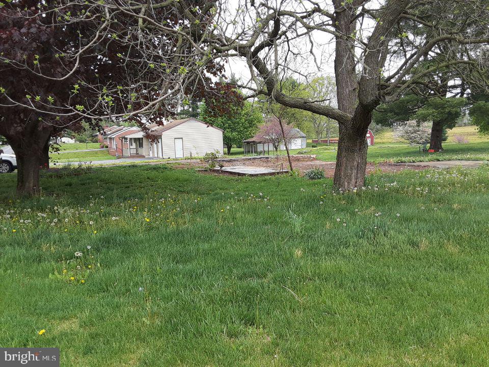 12635 Spickler Road Clear Spring, MD 21722 - Photo 2 of 4 a front view of a house with garden
