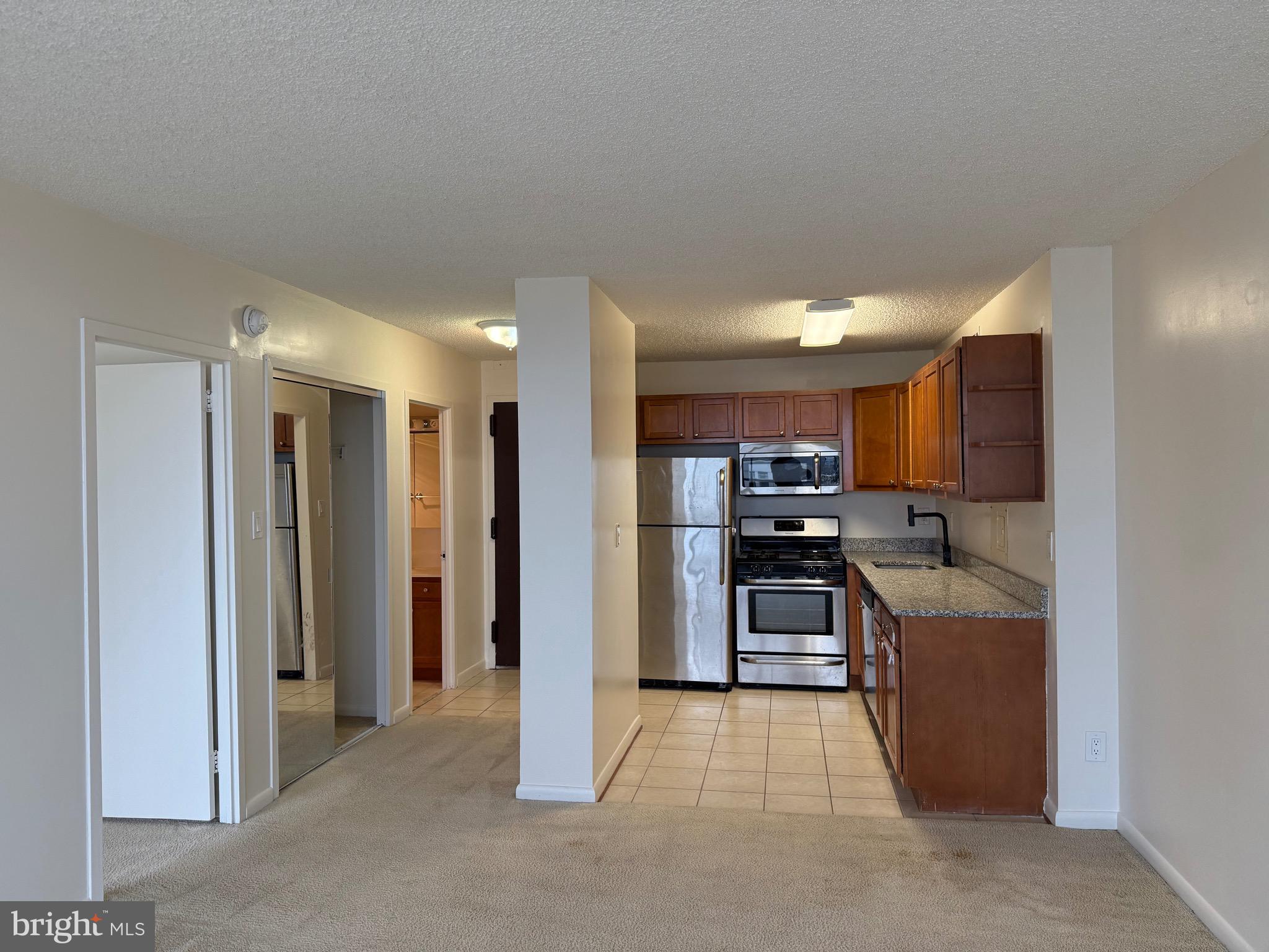 5225 Pooks Hill Road, Unit 1517N Bethesda, MD 20814 - Photo 3 of 30 a view of a kitchen with a sink refrigerator and a window