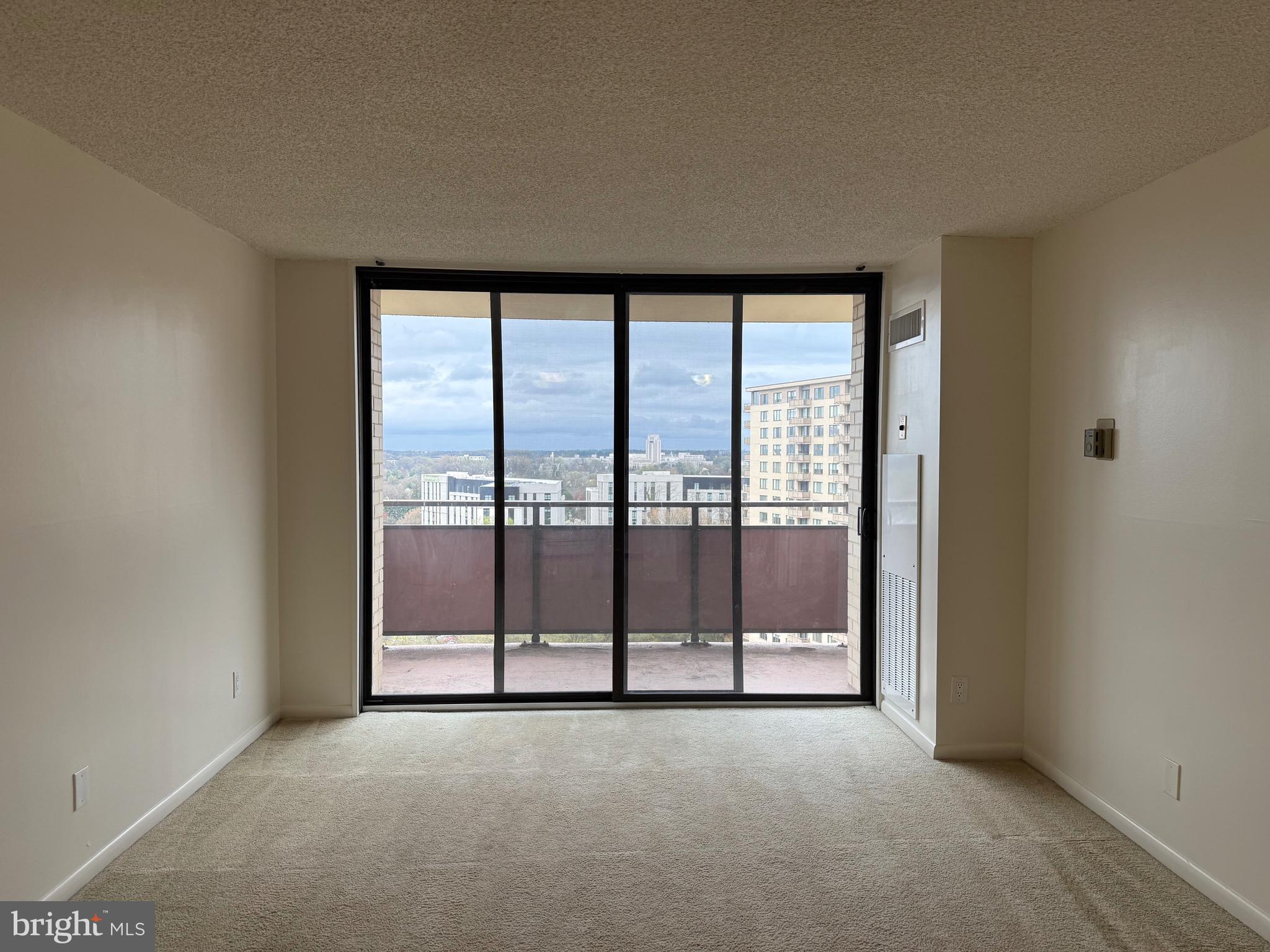 5225 Pooks Hill Road, Unit 1517N Bethesda, MD 20814 - Photo 5 of 30 a view of an empty room with wooden floor and next to a window