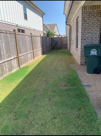 a view of a backyard with plants and a fireplace
