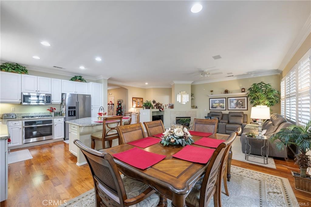 27956 Crystal Spring Drive Menifee, CA 92584 - Photo 12 of 25 a view of a dining room with furniture a kitchen and chandelier