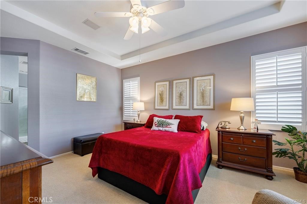 27956 Crystal Spring Drive Menifee, CA 92584 - Photo 14 of 25 a bedroom with a bed and a chandelier