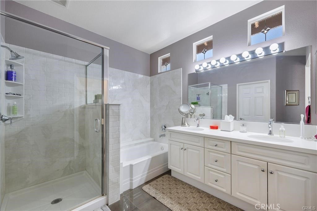 27956 Crystal Spring Drive Menifee, CA 92584 - Photo 15 of 25 a bathroom with a double vanity sink mirror and shower