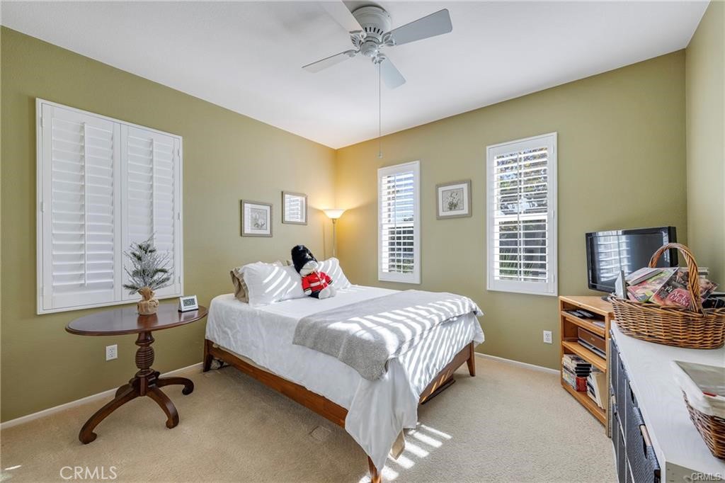 27956 Crystal Spring Drive Menifee, CA 92584 - Photo 16 of 25 a bedroom with a bed and a desk