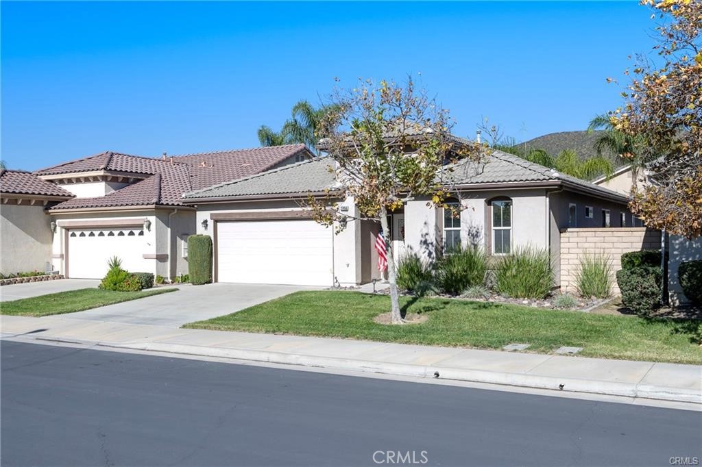 27956 Crystal Spring Drive Menifee, CA 92584 - Photo 2 of 25 a front view of a house with a yard and garage