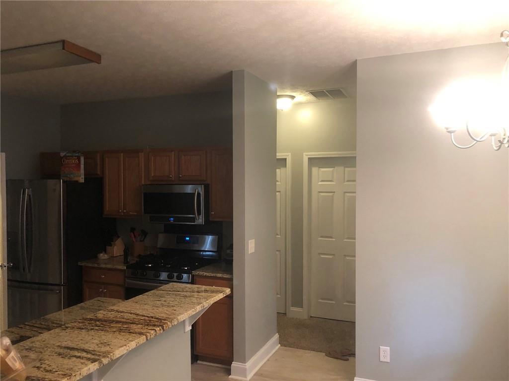 848 Windy Mill Court Temple, GA 30179 - Photo 14 of 19 a kitchen with kitchen island a sink stainless steel appliances and cabinets