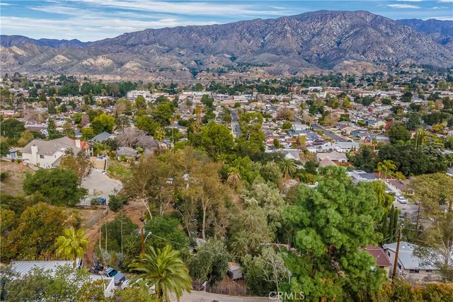 an aerial view of residential house and tree