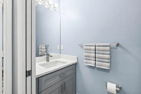 a kitchen with a sink a counter top space stainless steel appliances and cabinets