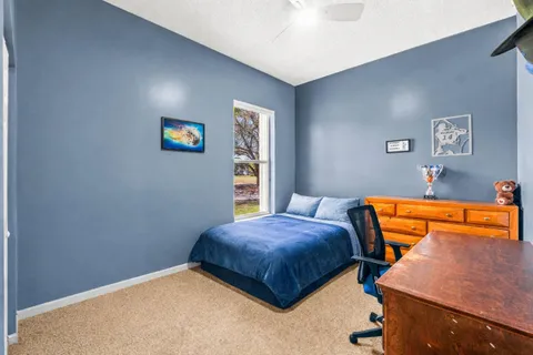 a bedroom with a bed and a couch