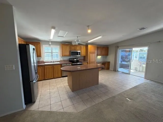 a large kitchen with cabinets and stainless steel appliances