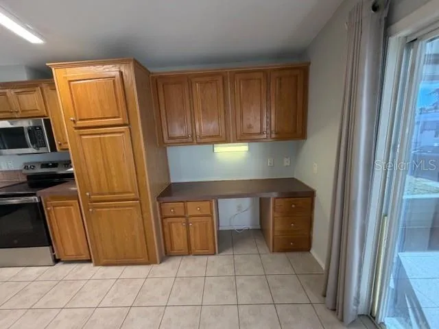 a kitchen with stainless steel appliances a stove sink and cabinets