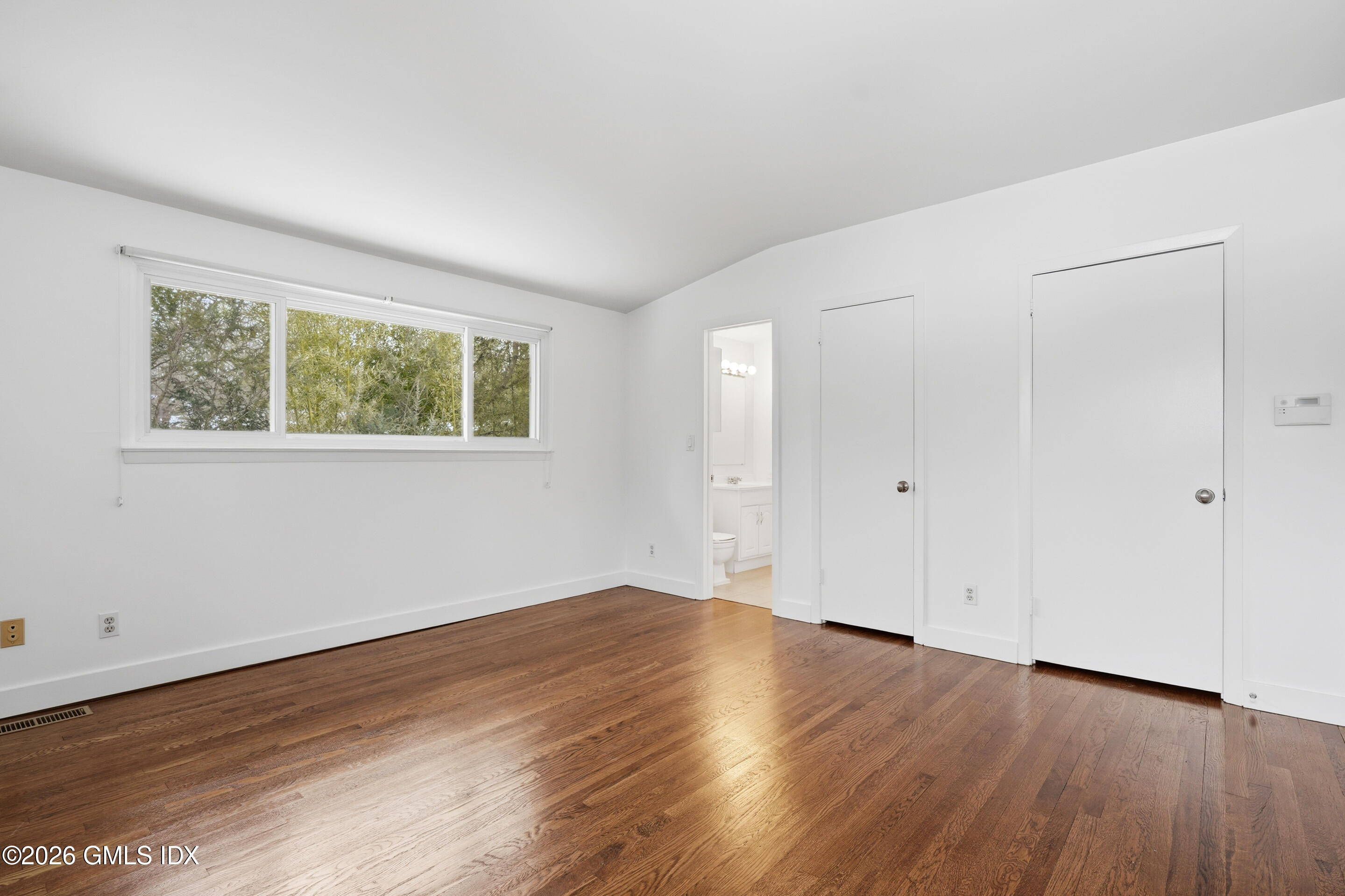 4 Split Timber Place Riverside, CT 06878 - Photo 23 of 38 a view of an empty room with wooden floor and a window