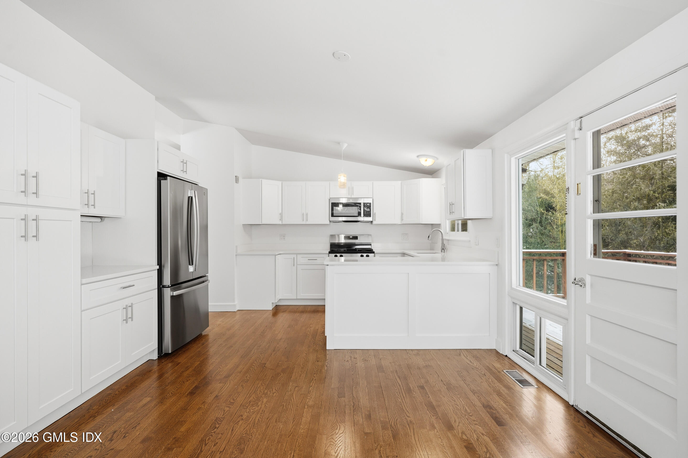 4 Split Timber Place Riverside, CT 06878 - Photo 32 of 38 a kitchen with wooden floors white cabinets and stainless steel appliances